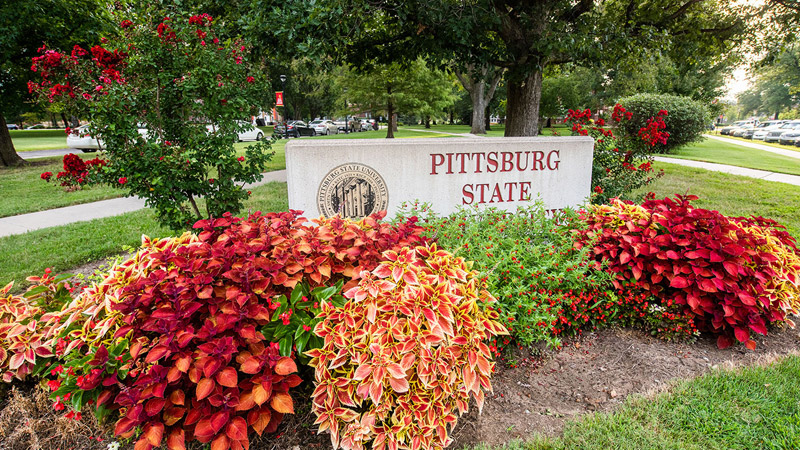 Outdoor photo of Pittsburg State sign among flowers
